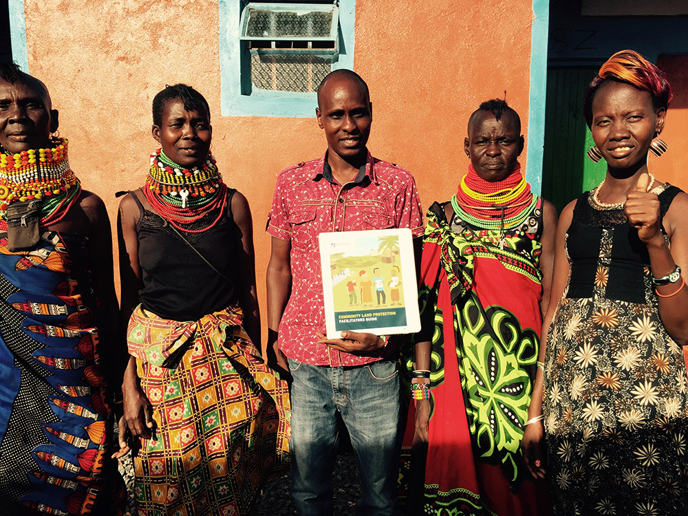 The women elected as Community Land Mobilizers in Turkana, Kenya standing with Kenya Land Alliance facilitator (center) and the Namati facilitators.