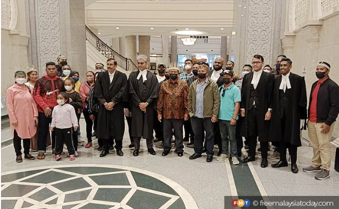 Members of the Orang Asli Seletar tribe with their lawyers at the Court of Appeal this morning.