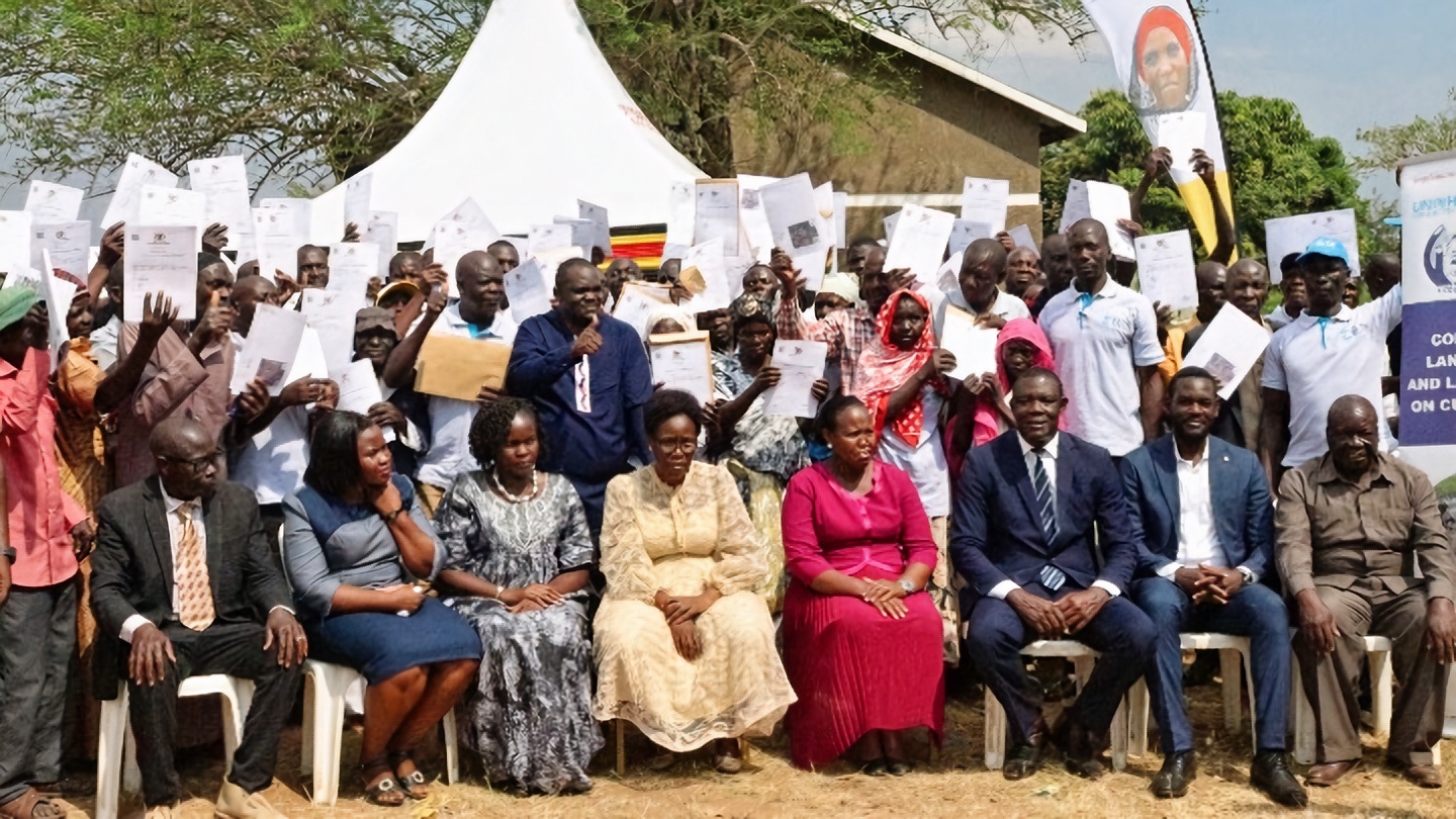 uganda Beneficiaries of Certificate of Customary Ownership pose for a photo with the Minister of Lands, Housing and Urban Development, Hon Judith Nabakooba in Butaleja disrtict.jp